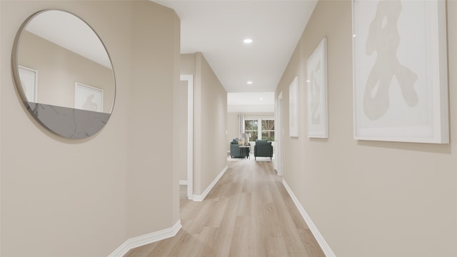 hallway with light hardwood / wood-style floors