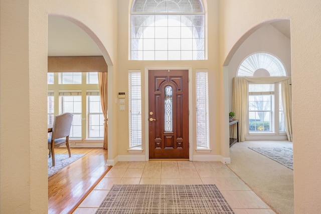 tiled foyer with a high ceiling