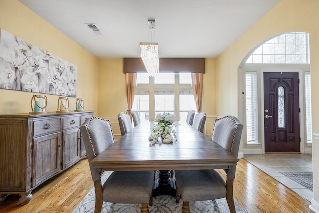 dining room with an inviting chandelier and light wood-type flooring