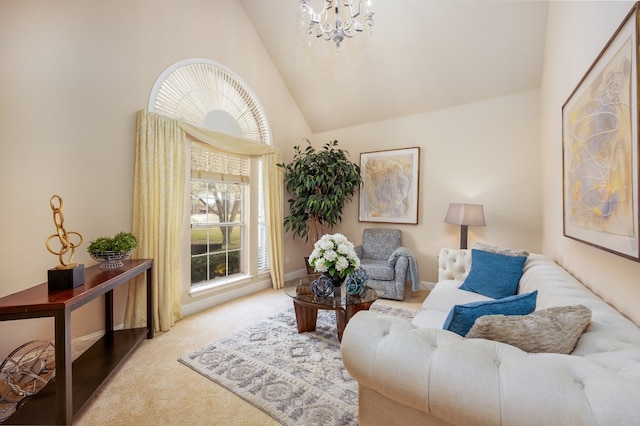 sitting room with an inviting chandelier, light colored carpet, and high vaulted ceiling