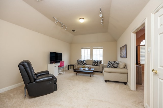 living room with lofted ceiling, rail lighting, and carpet flooring