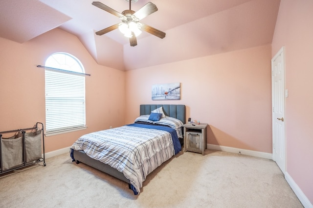 carpeted bedroom featuring lofted ceiling and ceiling fan