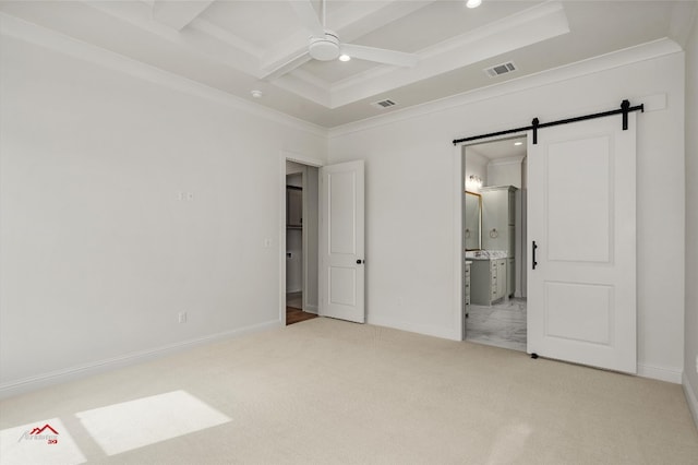 unfurnished bedroom with ceiling fan, ensuite bathroom, coffered ceiling, light tile flooring, and a barn door