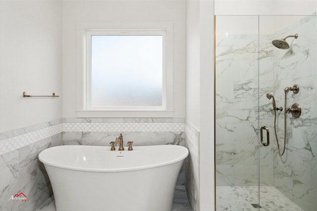 bathroom featuring separate shower and tub and tile walls