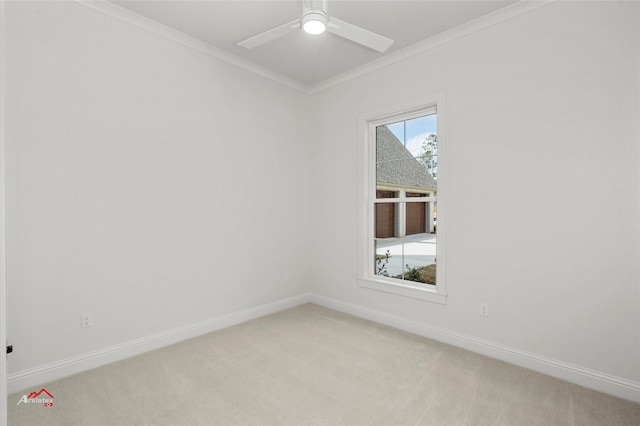 spare room with crown molding, ceiling fan, and light colored carpet