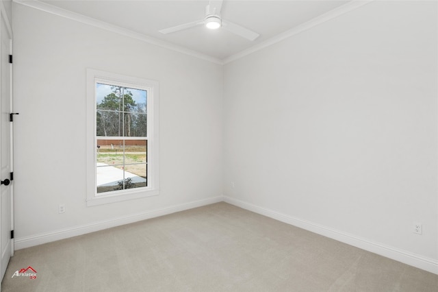 carpeted empty room featuring crown molding and ceiling fan