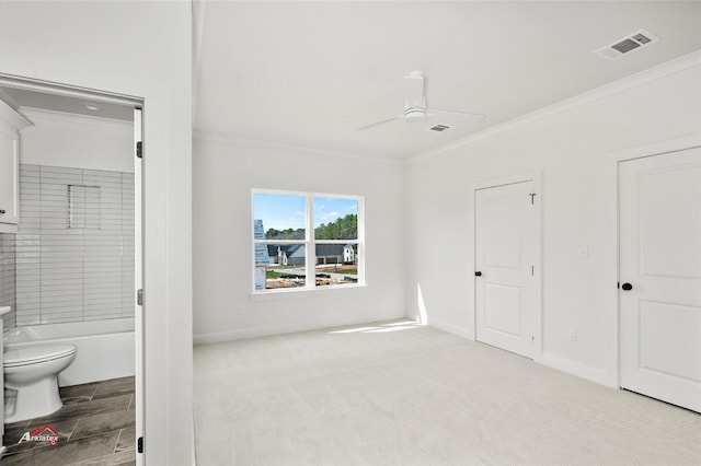 unfurnished bedroom with light carpet, connected bathroom, ornamental molding, and ceiling fan