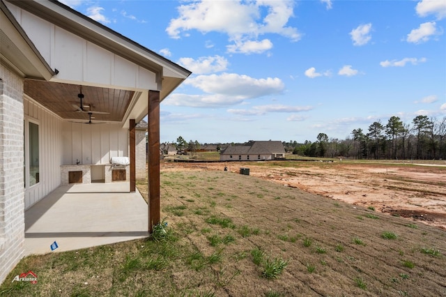 view of yard with a patio area and ceiling fan