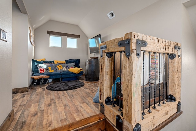 interior space with lofted ceiling and hardwood / wood-style flooring