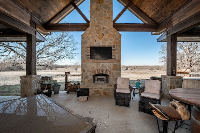 view of patio with an outdoor stone fireplace