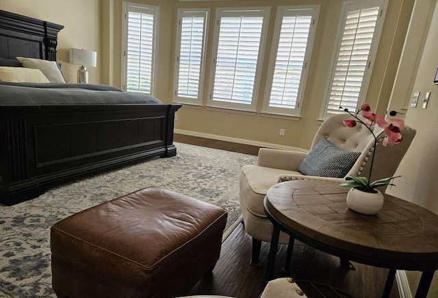 bedroom featuring dark hardwood / wood-style floors and multiple windows