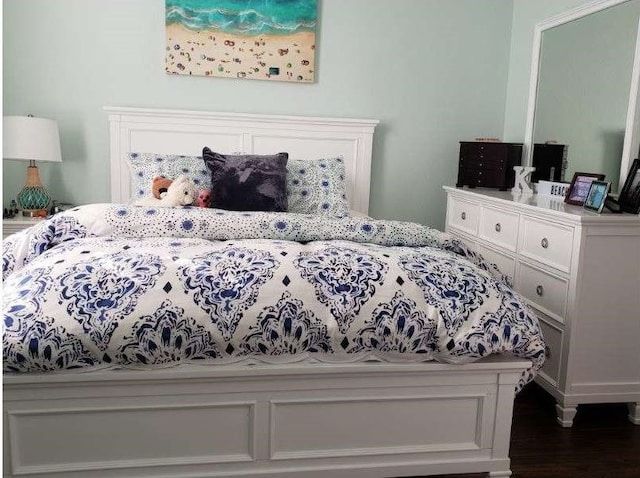 bedroom with dark hardwood / wood-style floors