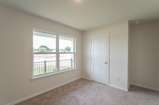 unfurnished bedroom with light colored carpet