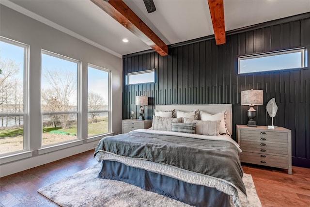 bedroom featuring beamed ceiling and dark hardwood / wood-style flooring