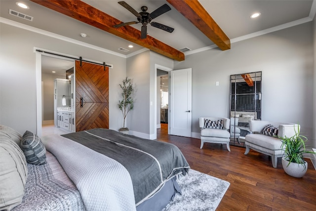 bedroom featuring dark hardwood / wood-style flooring, ceiling fan, a barn door, beamed ceiling, and ensuite bath