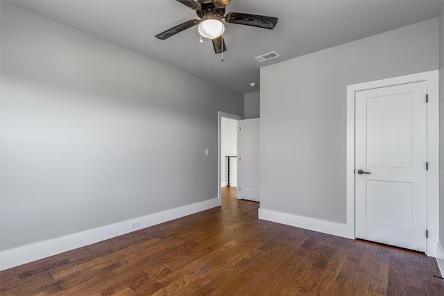 unfurnished bedroom featuring dark hardwood / wood-style floors and ceiling fan