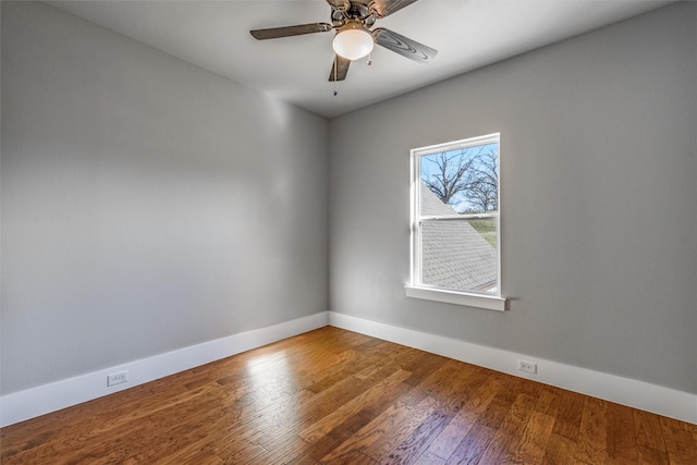 empty room with ceiling fan and hardwood / wood-style flooring