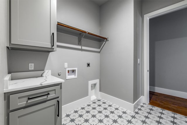 clothes washing area with cabinets, light tile flooring, gas dryer hookup, washer hookup, and hookup for an electric dryer