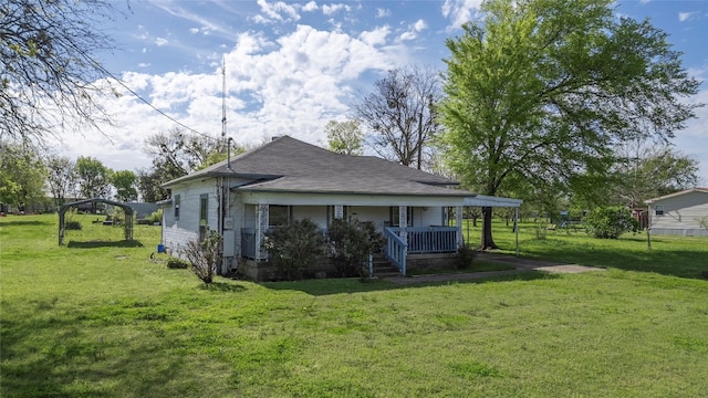 back of house with a porch and a yard