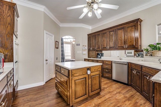 kitchen with a center island, dishwasher, ceiling fan, ornamental molding, and dark hardwood / wood-style floors