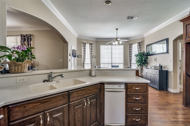 kitchen with dark brown cabinets, crown molding, hardwood / wood-style floors, ceiling fan, and sink