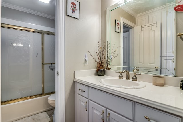 full bathroom with combined bath / shower with glass door, vanity with extensive cabinet space, toilet, and ornamental molding