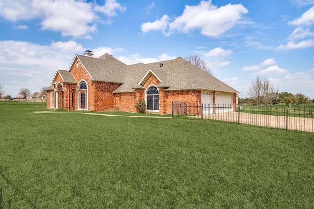 view of front of house featuring a front yard and a garage