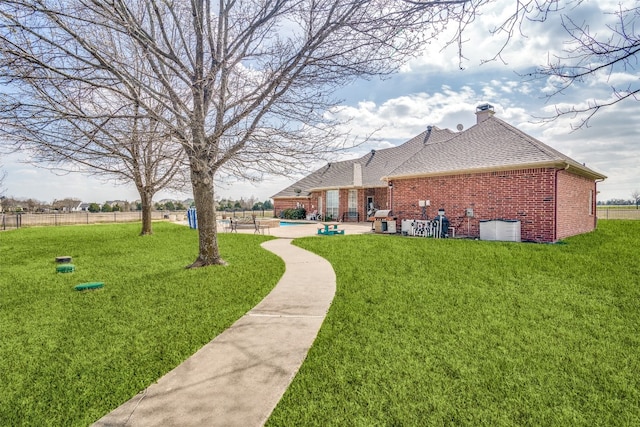 view of yard with a pool and a patio area