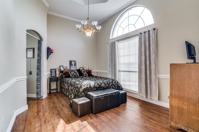 bedroom featuring a notable chandelier, crown molding, and dark hardwood / wood-style flooring