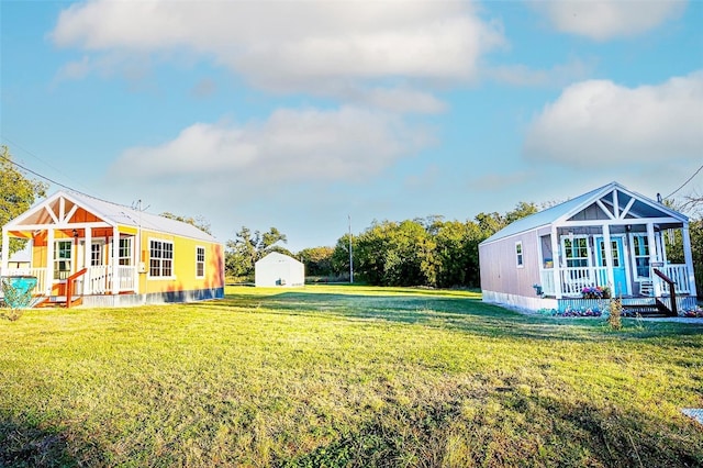 view of yard with an outdoor structure and a porch