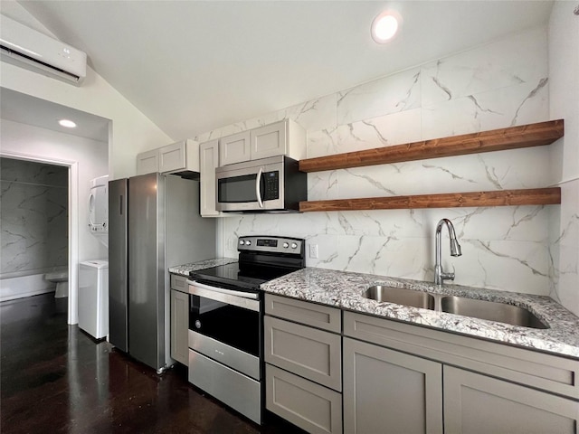 kitchen with appliances with stainless steel finishes, dark wood-type flooring, sink, lofted ceiling with beams, and stacked washer and dryer