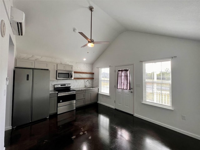 kitchen with ceiling fan, gray cabinets, sink, appliances with stainless steel finishes, and tasteful backsplash