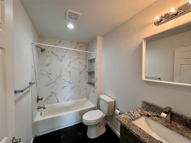 full bathroom featuring toilet, vanity, and tiled shower / bath