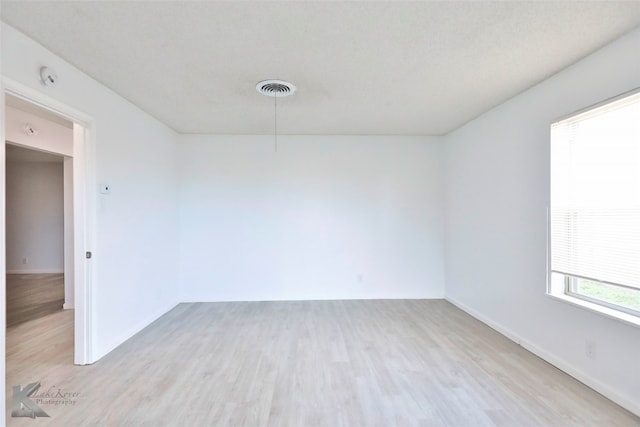 unfurnished room with light wood-type flooring