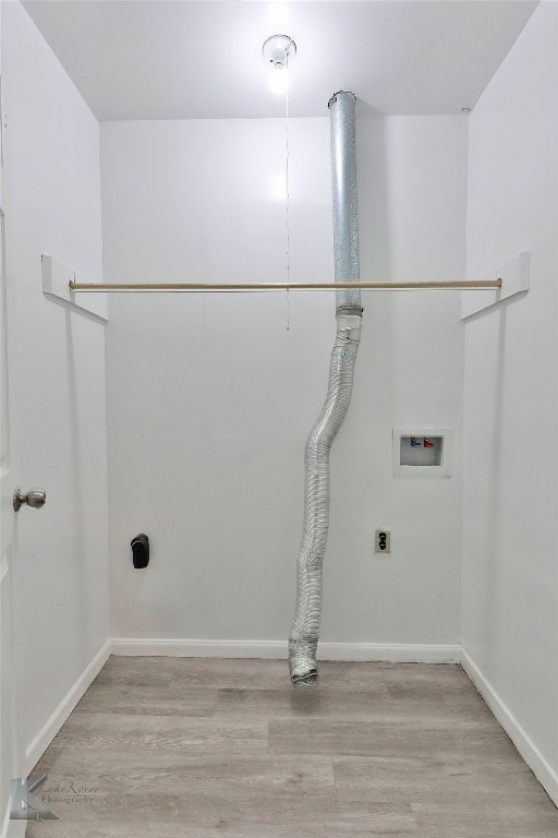 clothes washing area with electric dryer hookup, washer hookup, and light wood-type flooring