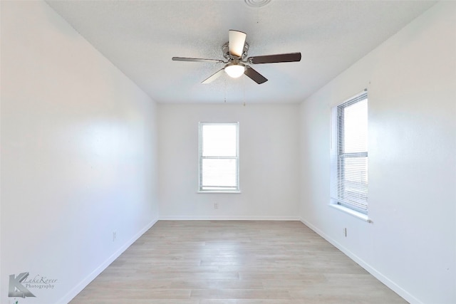 spare room featuring ceiling fan and light hardwood / wood-style floors