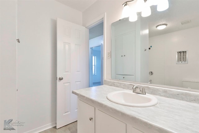 bathroom featuring toilet, large vanity, and hardwood / wood-style floors