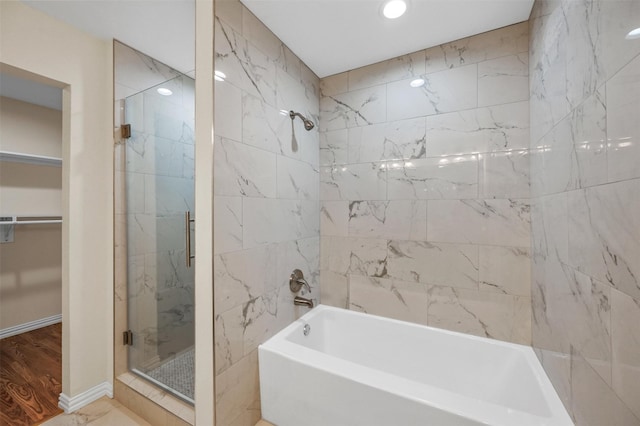 bathroom with an enclosed shower and wood-type flooring