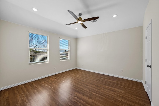 empty room featuring dark hardwood / wood-style flooring and ceiling fan