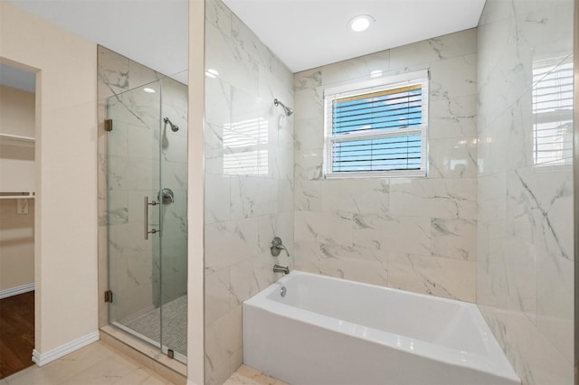 bathroom featuring independent shower and bath and tile floors