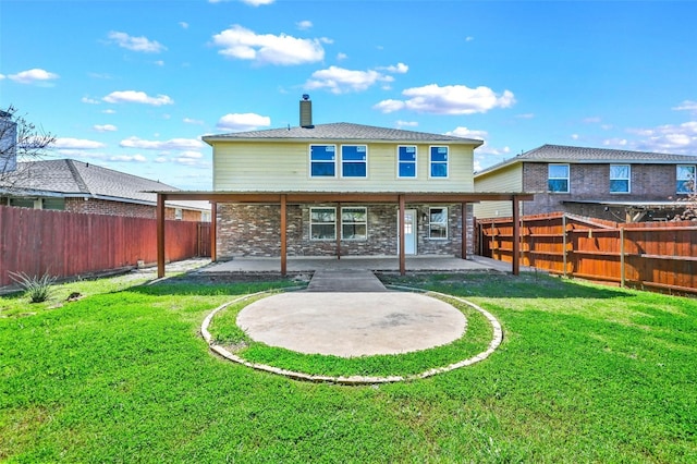 rear view of property with a yard and a patio