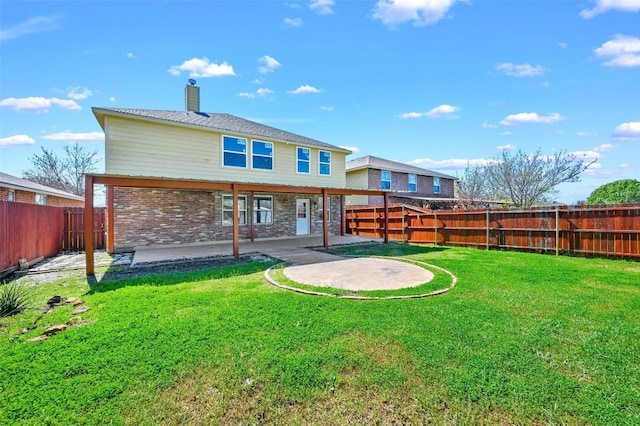 rear view of house featuring a patio and a yard