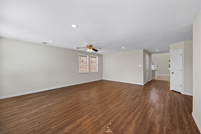 spare room featuring ceiling fan and dark wood-type flooring