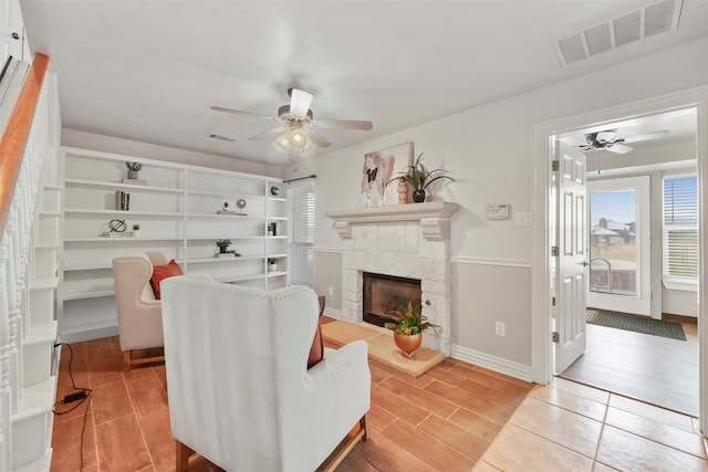 living room featuring ceiling fan and light hardwood / wood-style floors