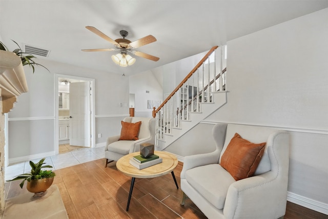 living room with ceiling fan and light wood-type flooring