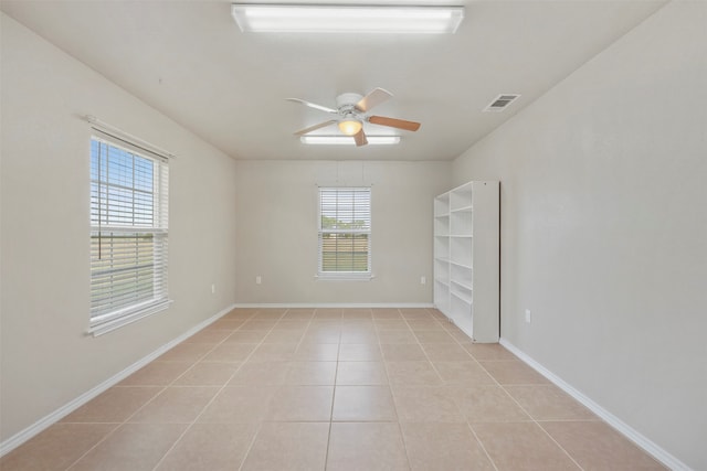 unfurnished room featuring light tile patterned floors and ceiling fan