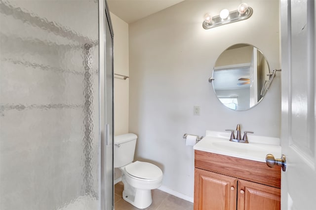 bathroom featuring vanity, toilet, tile patterned floors, and walk in shower