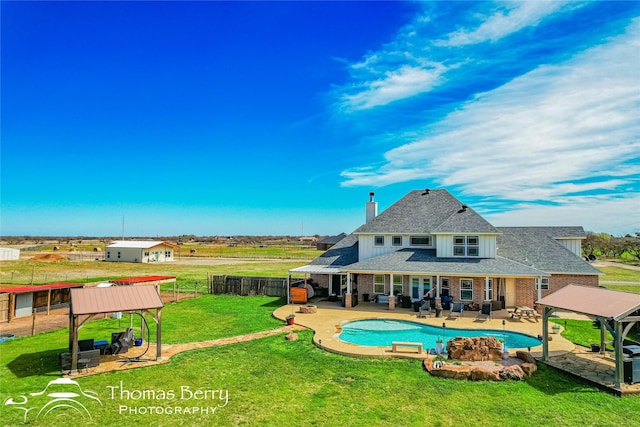 view of swimming pool featuring a gazebo, a patio area, an outdoor living space, and a yard