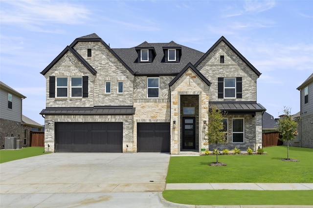 view of front of home featuring a front yard, a garage, and central AC unit