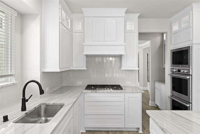 kitchen with sink, white cabinets, and appliances with stainless steel finishes